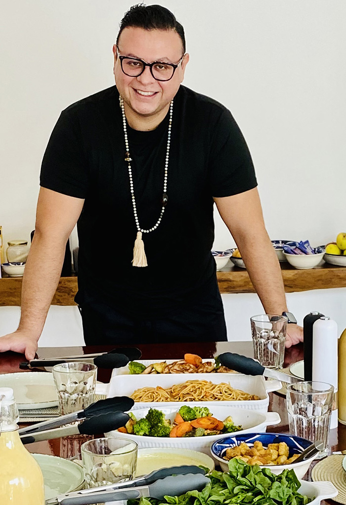 Beond Ibogaine Cancun, Mexico facilities: Chef standing at head of table with freshly prepared food.