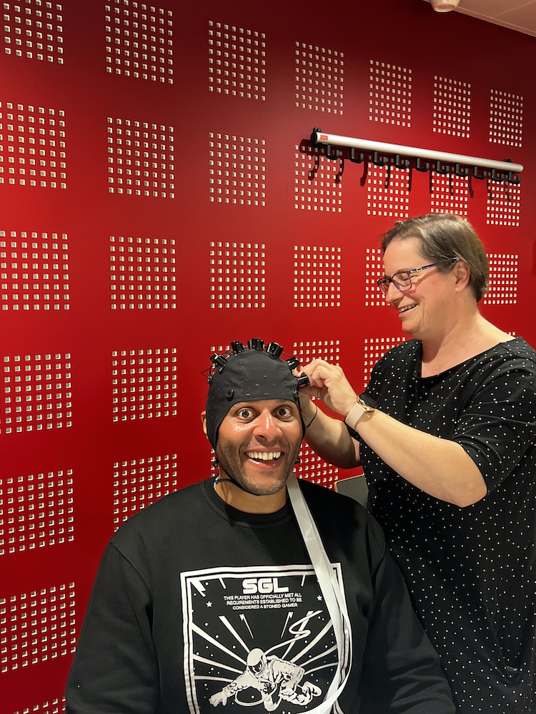 Neuroscience student Zeus Tipado participating in fNIRS treatment