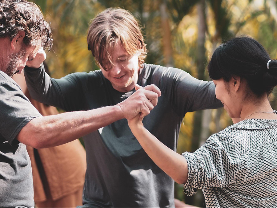 Retreat participants holding hands at Soul Medicine, psilocybin retreat in Nayarit, Mexico.